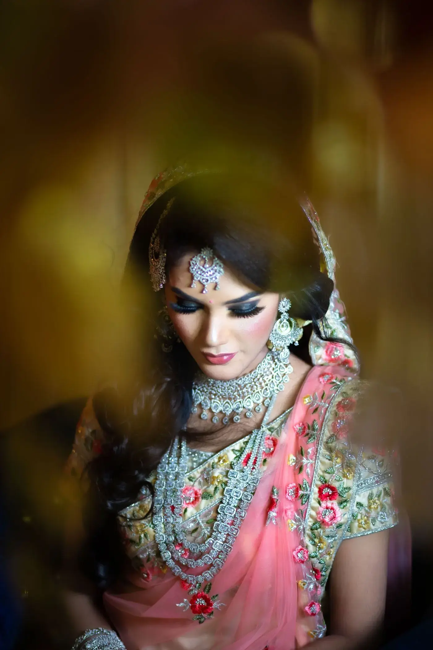 A bride in blush pink with a maang tikka