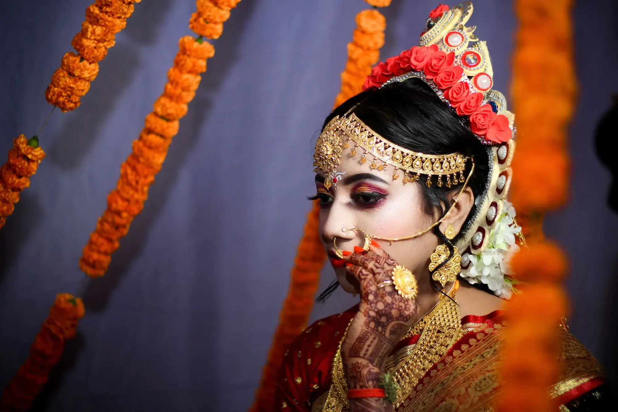 A bride putting on a nath